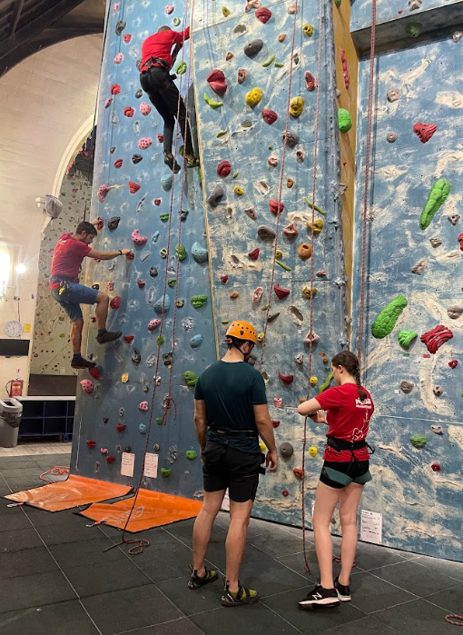 Students climbing an indoor rock wall